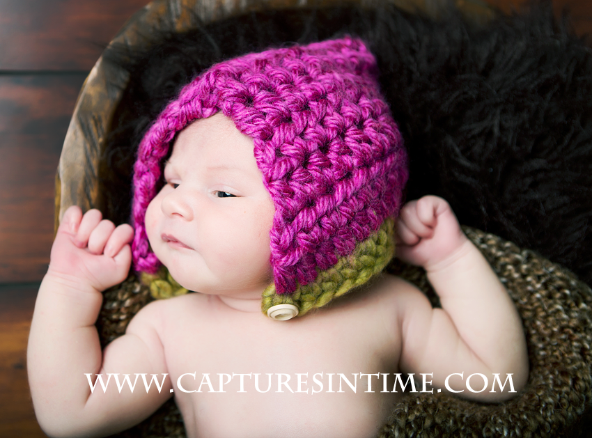 newborn and pink hat
