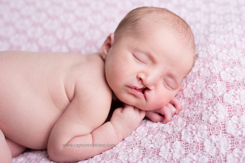 kansas city newborn baby photography newborn girl on pink fabric close up