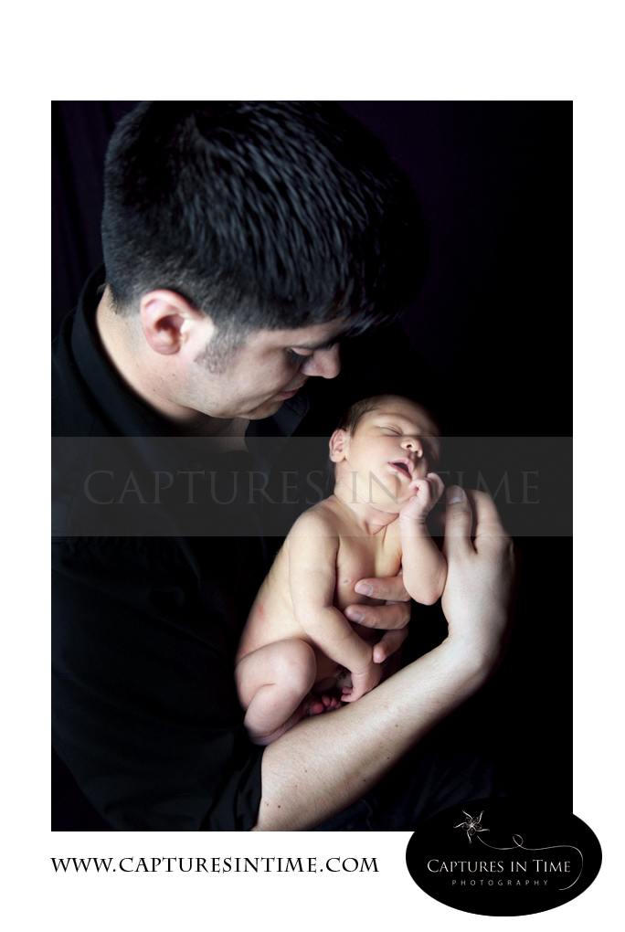 Kansas City Newborn Photographer dad holding preemie