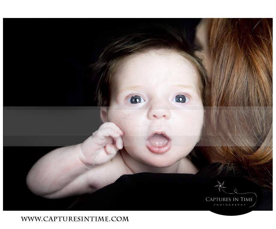 3 Weeks Kansas City Newborn Photographer mom holding baby with big eyes