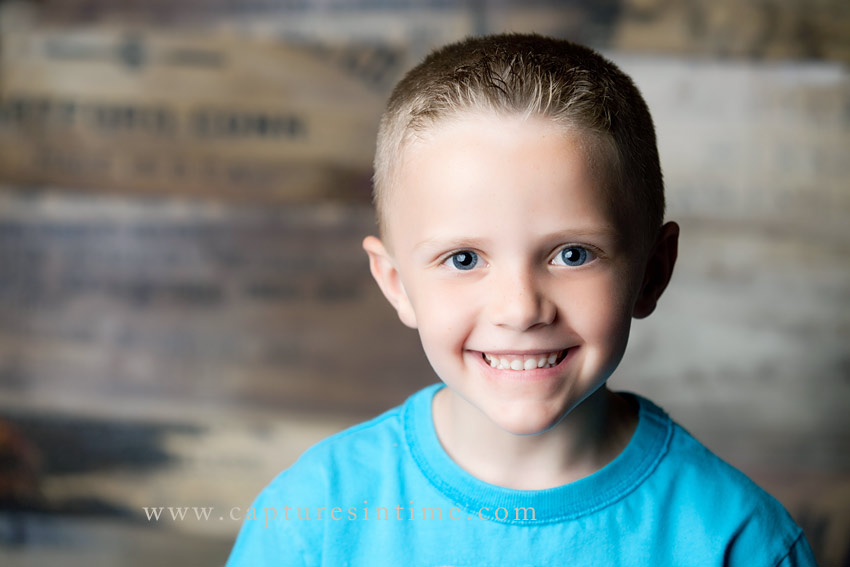 Blue Springs Child Photographer boy with big eyes on palette backdrop