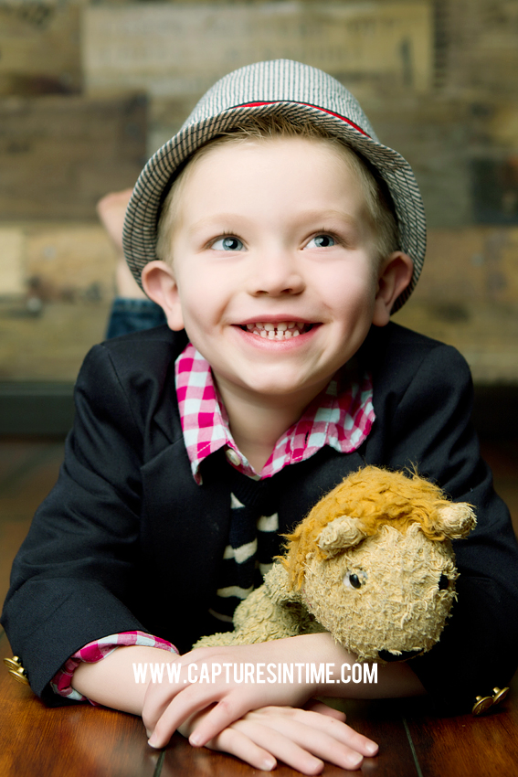 boy with hat and stuffed animal