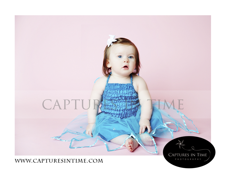 Adorableness Kansas City Photographer one year old on pink backdrop