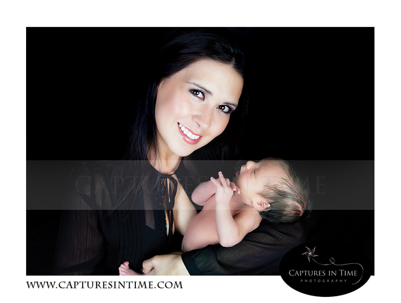 Kansas City Newborn Photography gorgeous mom holds her newborn in all black