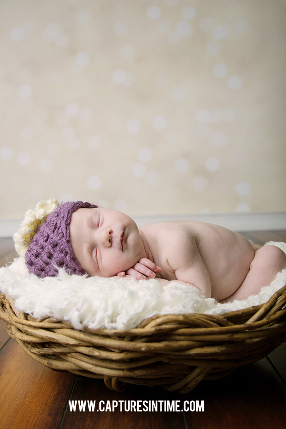 newborn in purple hat