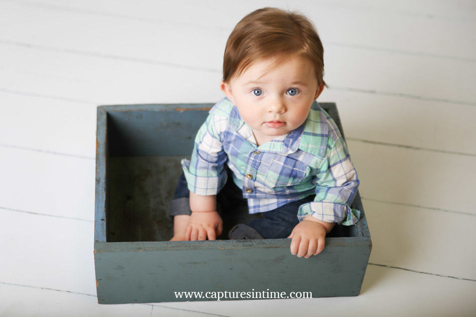 baby photography kansas city baby with red hair and plaid shirt sitting in a blue box