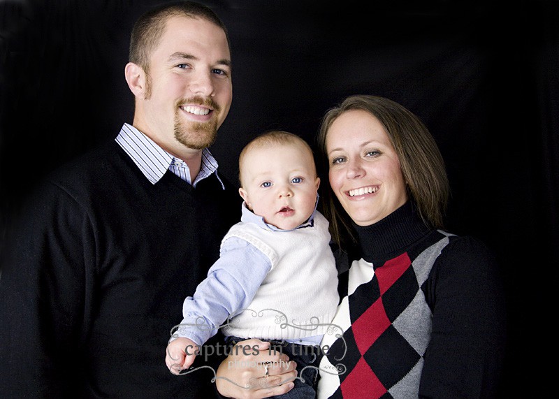 family black and red clothing with baby