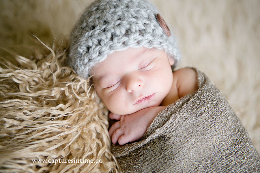 Sweet Newborn With Big Brother sweet little newborn baby with grey hat and wooden button