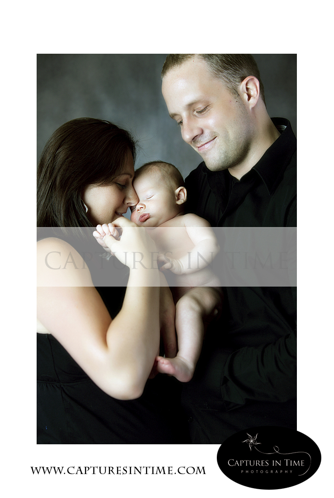 Kansas City Newborn Photographer newborn snuggling with his parents