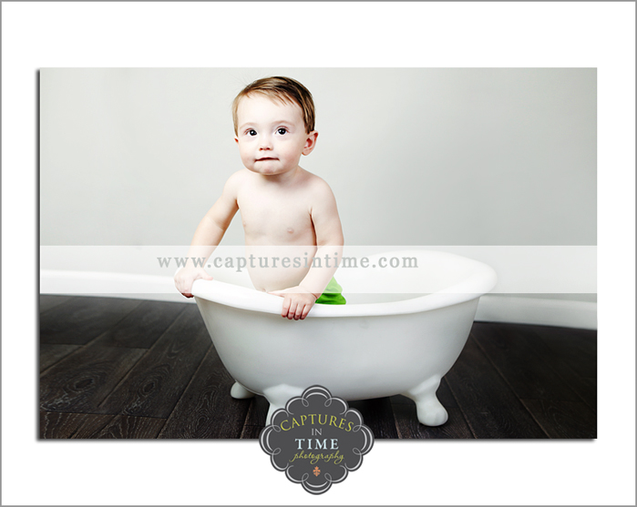 baby boy in a bathtub grey backdrop