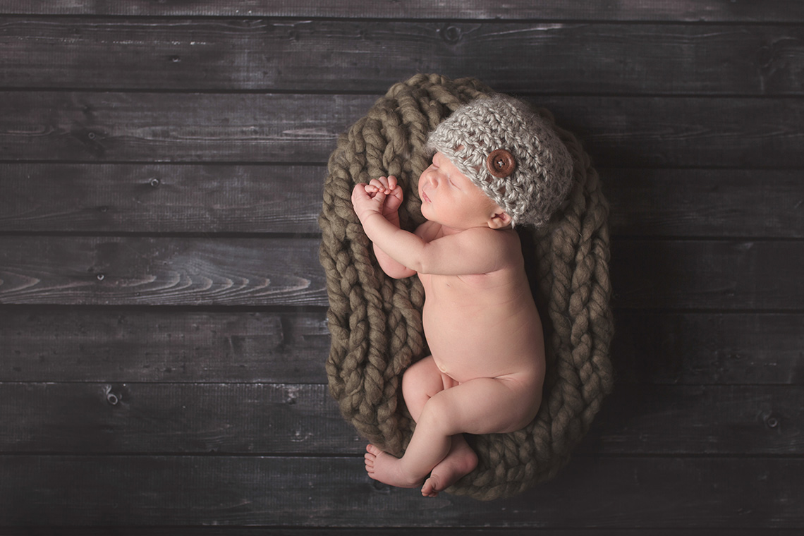 Newborn Photo Shoot in Kansas City newborn photo shoot grey wood baby in hat