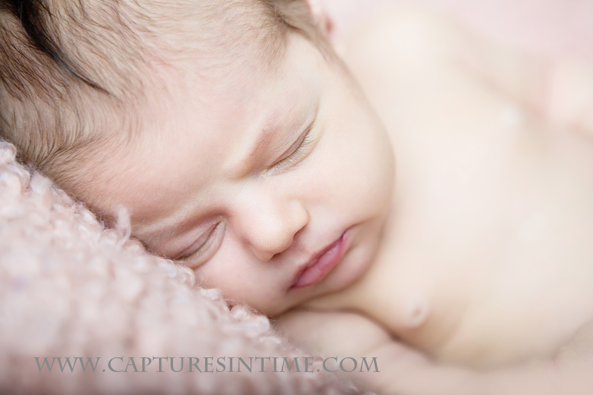 Kansas City Newborn Girl Photos baby girl on soft pink blanket