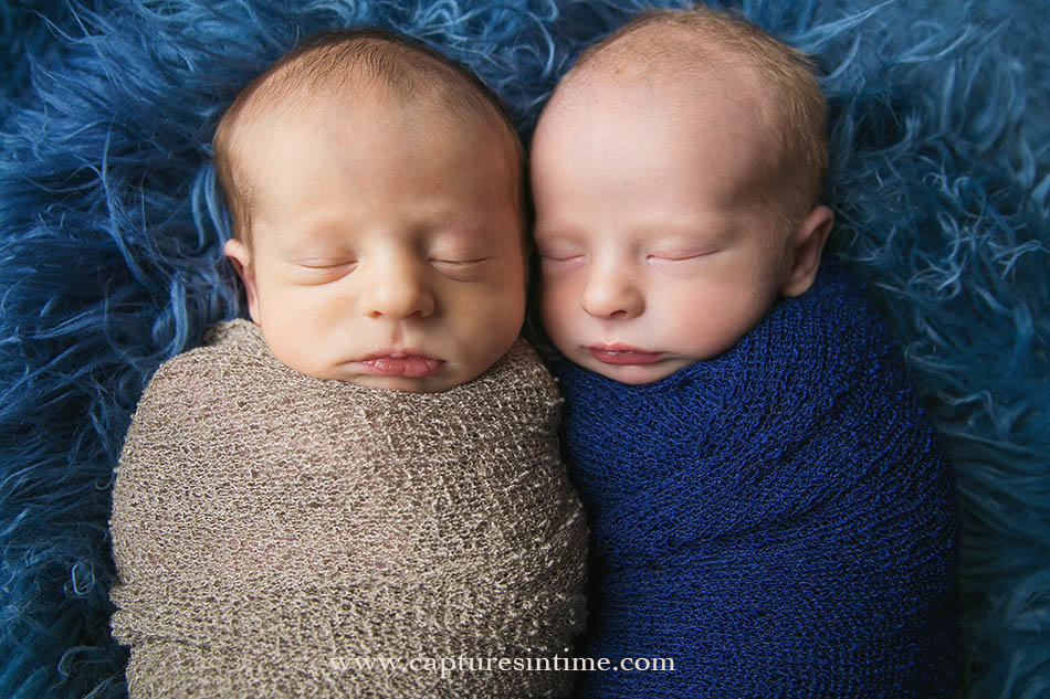newborn twins on blue blanket