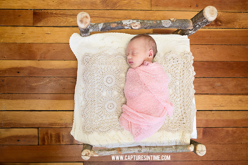 Grain Valley Newborn Photography newborn baby girl on crochet blanket lying on a birch bed