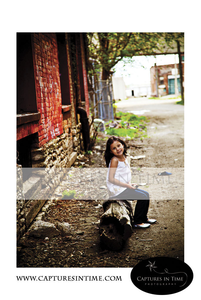 Kansas City Photographer girl sitting on a tree stump in Rivermarket
