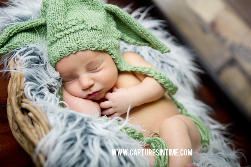 newborn boy sleeping with yoda hat