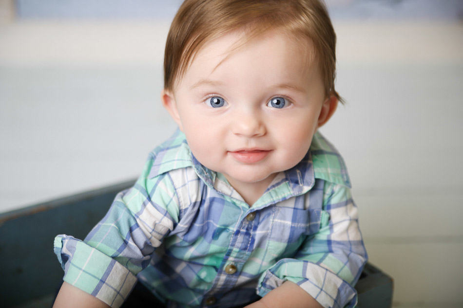 baby photography kansas city red head baby boy with plaid shirt on sitting in a box