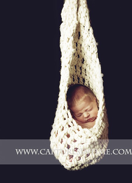 Kansas City Newborn Photographer photographs baby in knit slng