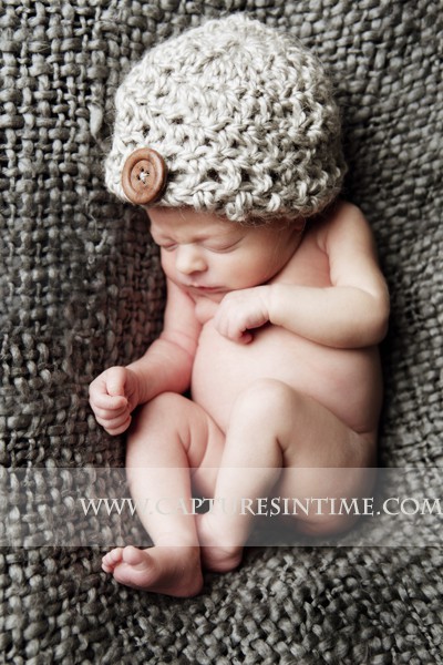 Kansas City Newborn Photography newborn nestled in grey blanket with hat on